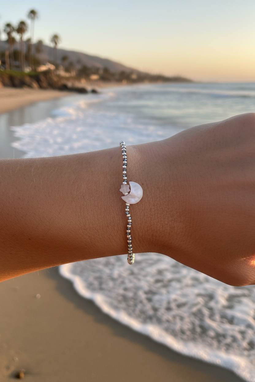 Girl wearing moon bracelet on the beach